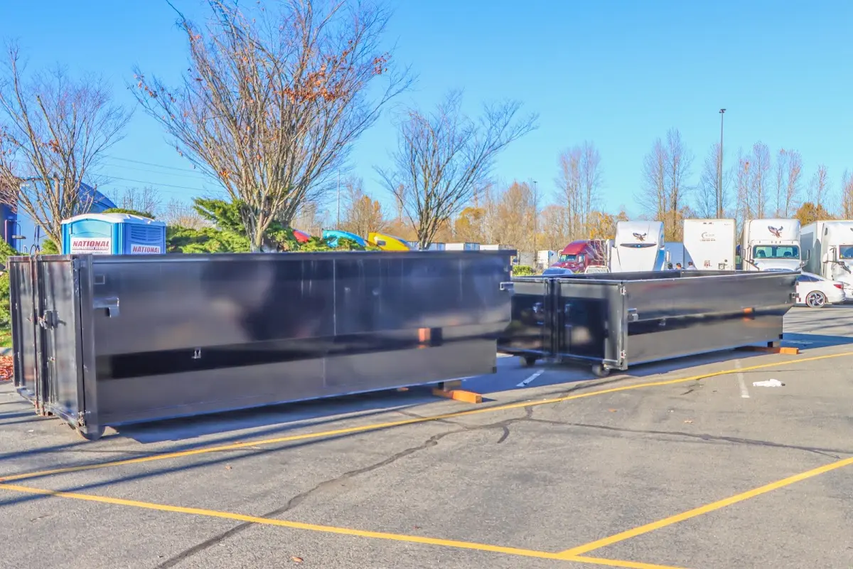 Professional dumpster rental service with roll-off container on residential driveway in Camp Springs